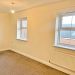 Bright room with two windows and light carpet