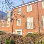 Brick townhouse with balcony and satellite dish