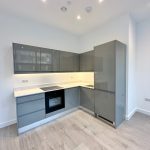 Modern grey kitchen with integrated appliances.