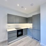 Modern kitchen with grey cabinets and appliances.