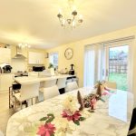 Bright kitchen with dining table and festive decorations.