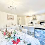 Modern kitchen with festive dining table setting.