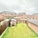 View of suburban back garden with wooden sheds.