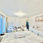 Modern dining room with festive decorations.