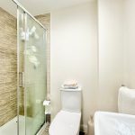 Modern bathroom with shower, toilet, and basin.