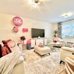 Cosy living room with balloons and gifts.