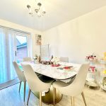 Modern dining room with marble table and chairs.