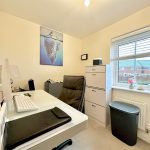 Modern home office with window view and artwork