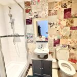 Stylish bathroom with shower and floral wallpaper
