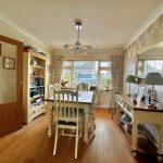 Bright dining room with bookshelves and table.