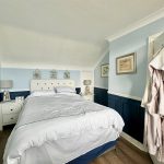 Cosy bedroom with nautical decor and soft lighting.