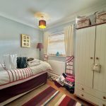 Cosy bedroom with bed and wardrobe