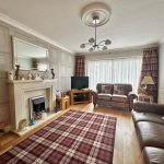 Cozy living room with leather sofas and fireplace.
