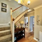 Cosy hallway with staircase and wooden floor.