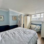 Cosy bedroom with blue and white decor.