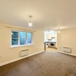 Spacious living room with kitchen view.
