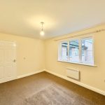 Empty room with window and carpet floor.