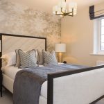 Stylish modern bedroom with decorative pillows and lamps.