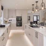 Modern kitchen with sleek white cabinets and island.