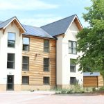 Modern building with solar panels and greenery