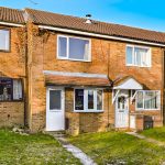 Red brick terraced houses with front gardens.