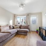 Modern living room with corner sofa and TV.
