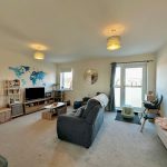 Modern living room with map wall art and sofa.