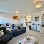 Modern open-plan living room and kitchen area.