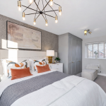 Modern bedroom with stylish decor and lighting.