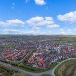 Aerial view of suburban housing and countryside panorama.