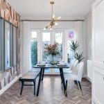 Modern dining room with table and chairs setup.