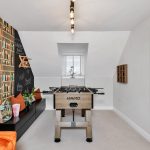 Stylish games room with foosball table and artwork.