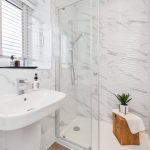 Modern bathroom with marble design and shower.
