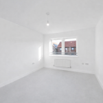 Empty bright room with window and radiator