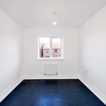 Minimalistic empty room with window and radiator