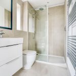 Modern bathroom with shower, sink, and toilet