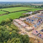 Aerial view of housing development and surrounding countryside.