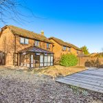 Backyard of house with conservatory and patio.