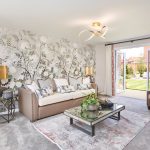 Bright living room with floral wallpaper and garden view.