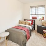 Cosy bedroom with bed and decorative details.