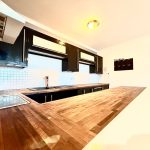 Modern kitchen with wood countertops and black cabinets