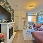 Modern living room with tropical wallpaper and decor.
