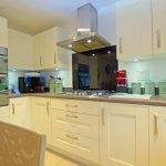 Modern kitchen with white cabinets and appliances