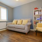 Cosy sitting room with grey sofa and armchair
