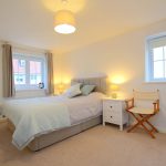 Cosy bedroom with double bed and bedside tables.