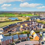 Aerial view of suburban housing development and pond.