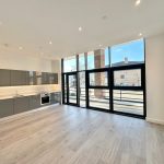 Spacious modern kitchen with floor-to-ceiling windows.
