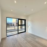 Bright modern room with large floor-to-ceiling window.