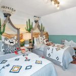 Twin bedroom with desert-themed decor.
