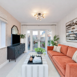 Modern living room with orange sofa and artwork.